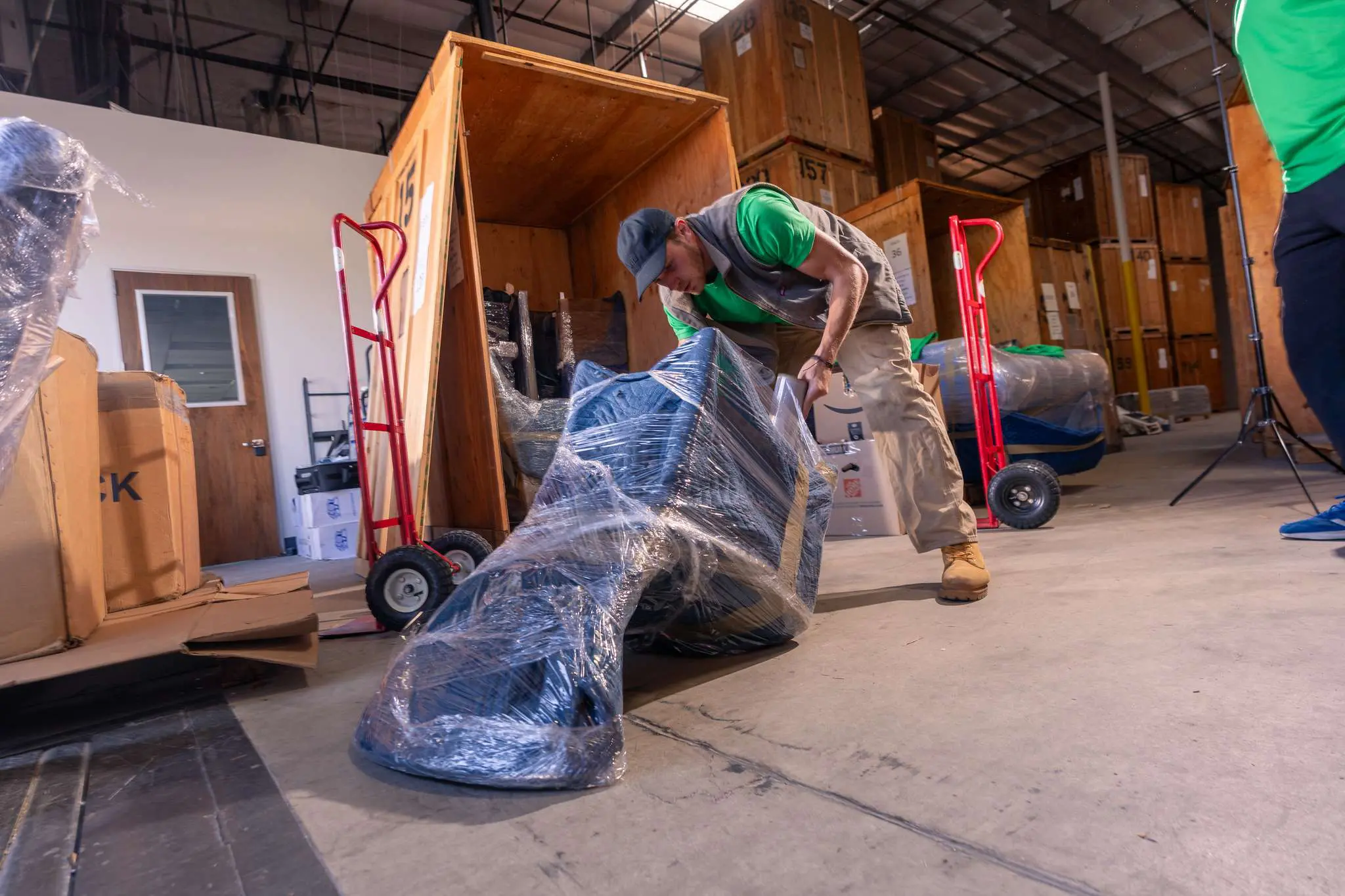 Crew wrapping furniture for storage