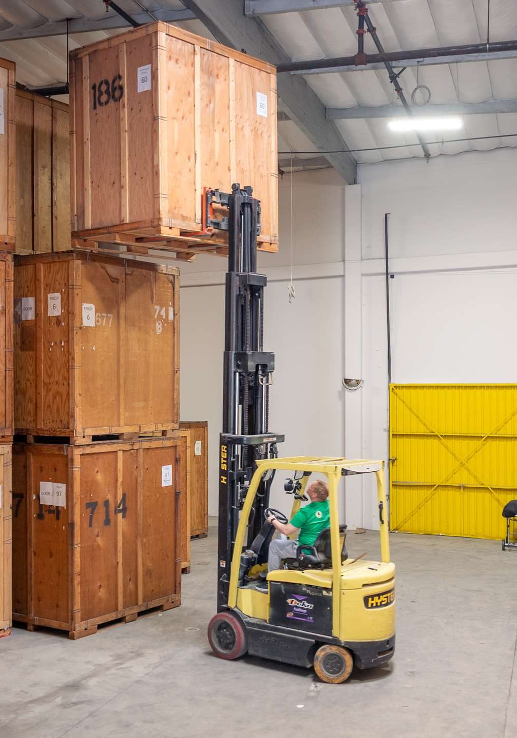 Finch forklift stacking storage crates in the warehouse